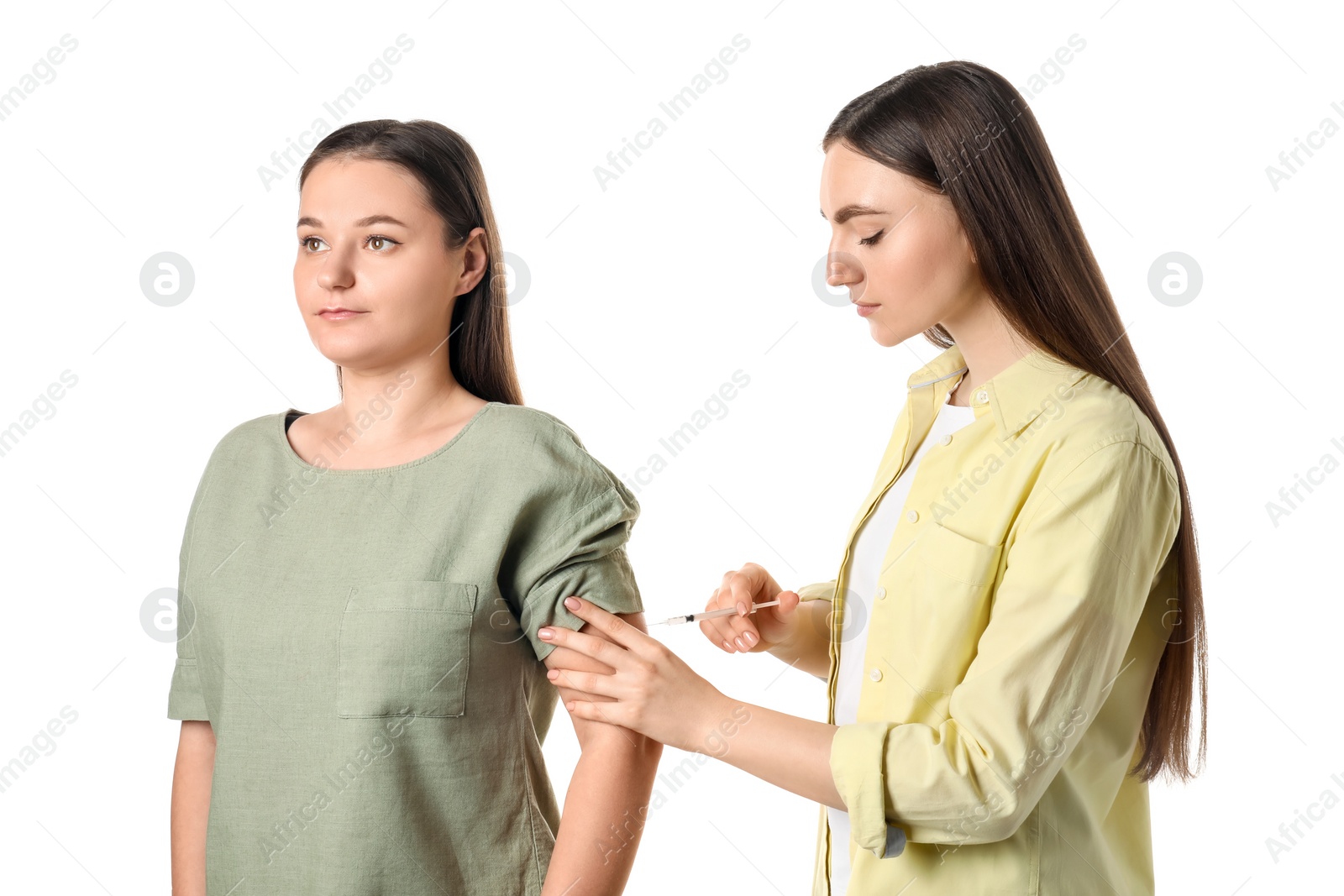 Photo of Woman giving insulin injection to her diabetic friend on white background