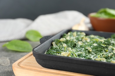 Photo of Tasty spinach dip on table, closeup view