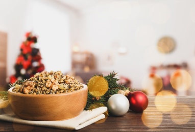 Image of Traditional Christmas slavic dish kutia on wooden table in decorated room. Space for text