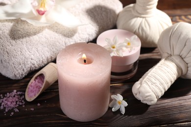 Photo of Composition with spa supplies and flowers on wooden table