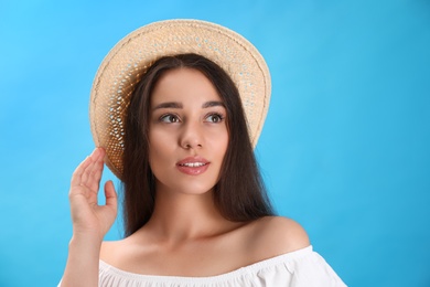 Photo of Portrait of beautiful young woman on light blue background