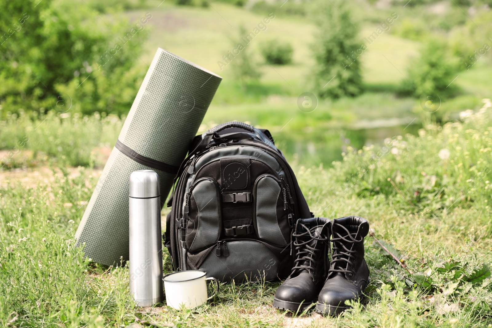 Photo of Set of camping gear outdoors on sunny day
