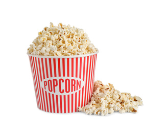 Photo of Delicious popcorn in paper bucket isolated on white