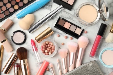 Photo of Flat lay composition with makeup products on white marble table