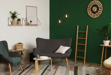 Photo of Modern living room interior stylish sofa near green wall