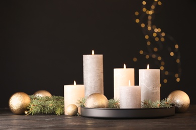 Photo of Burning candles with Christmas decoration on table. Space for text