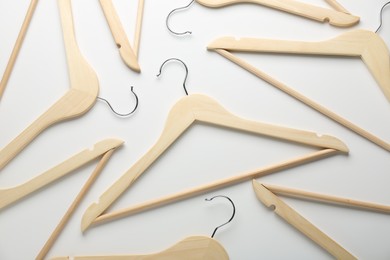 Photo of Wooden hangers on white background, flat lay