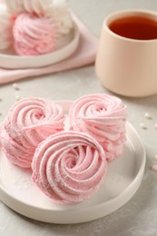 Photo of Delicious pink marshmallows on light grey table