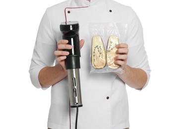 Photo of Chef holding sous vide cooker and eggplant in vacuum pack on white background, closeup