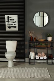 Photo of Modern bathroom interior with toilet bowl and console table