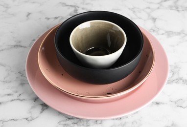 Photo of Stack of clean dishes on white marble table