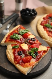 Photo of Slices of delicious pita pizza on wooden board, closeup