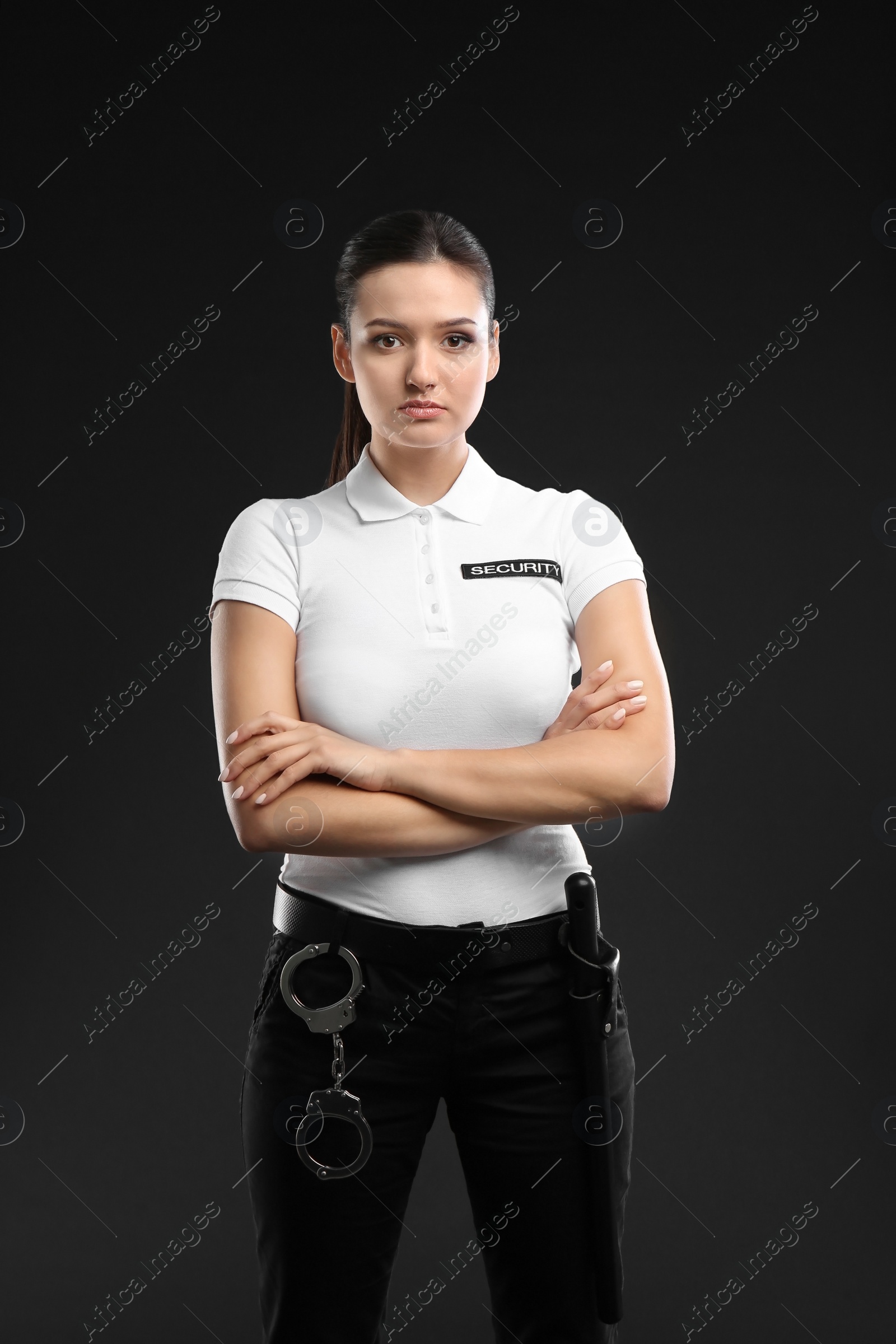 Photo of Female security guard in uniform on dark background