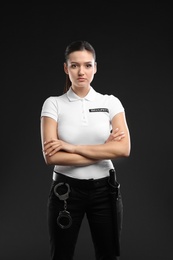 Photo of Female security guard in uniform on dark background