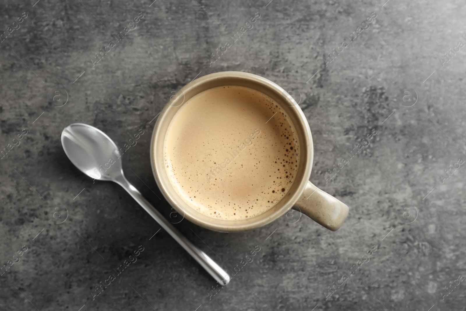 Photo of Cup of aromatic hot coffee on grey background, top view