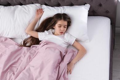 Beautiful little girl sleeping in bed at home