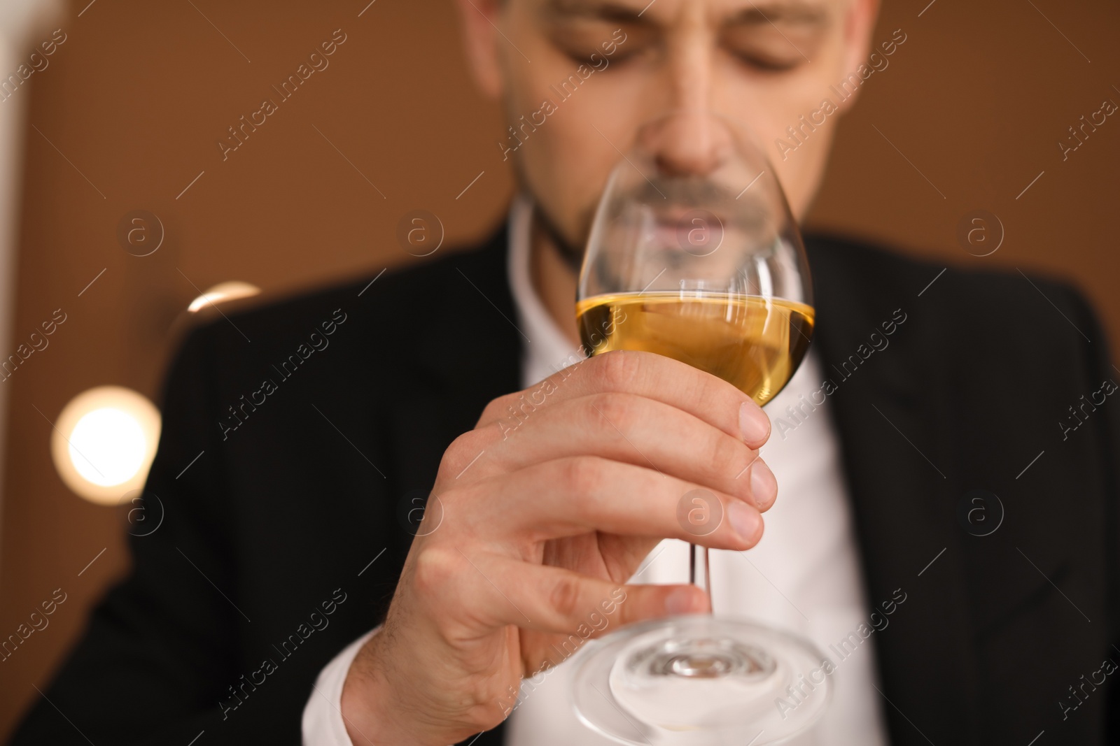 Photo of Young man with glass of wine indoors