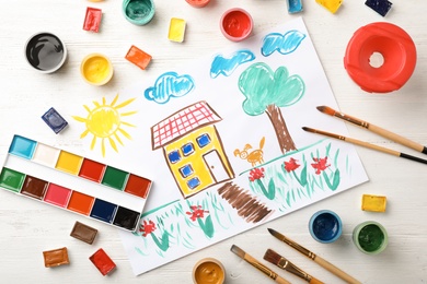Photo of Flat lay composition with child's painting of house on table
