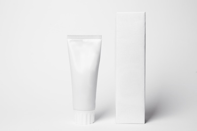 Photo of Blank tube of toothpaste and box on white background