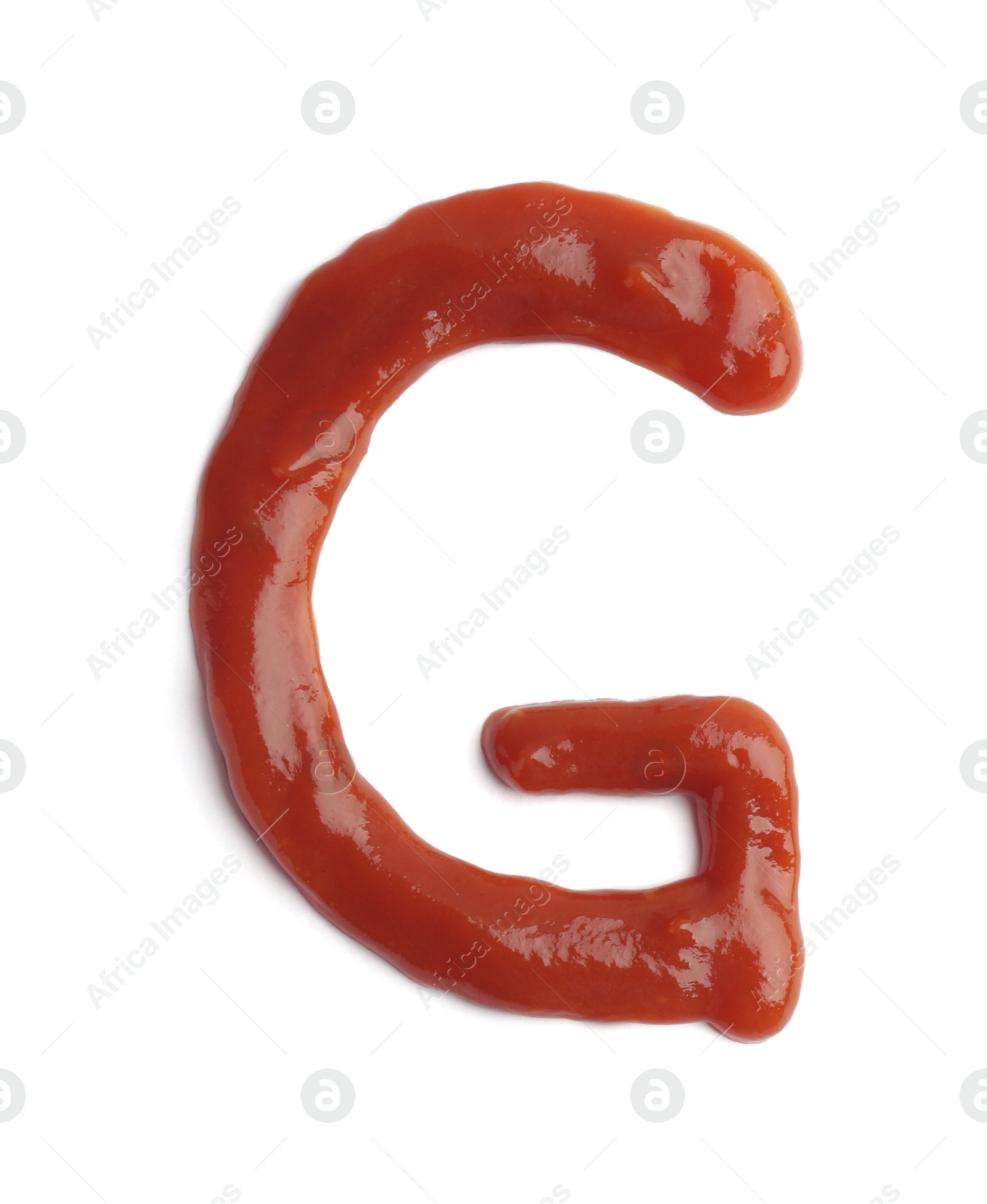 Photo of Letter G written with ketchup on white background