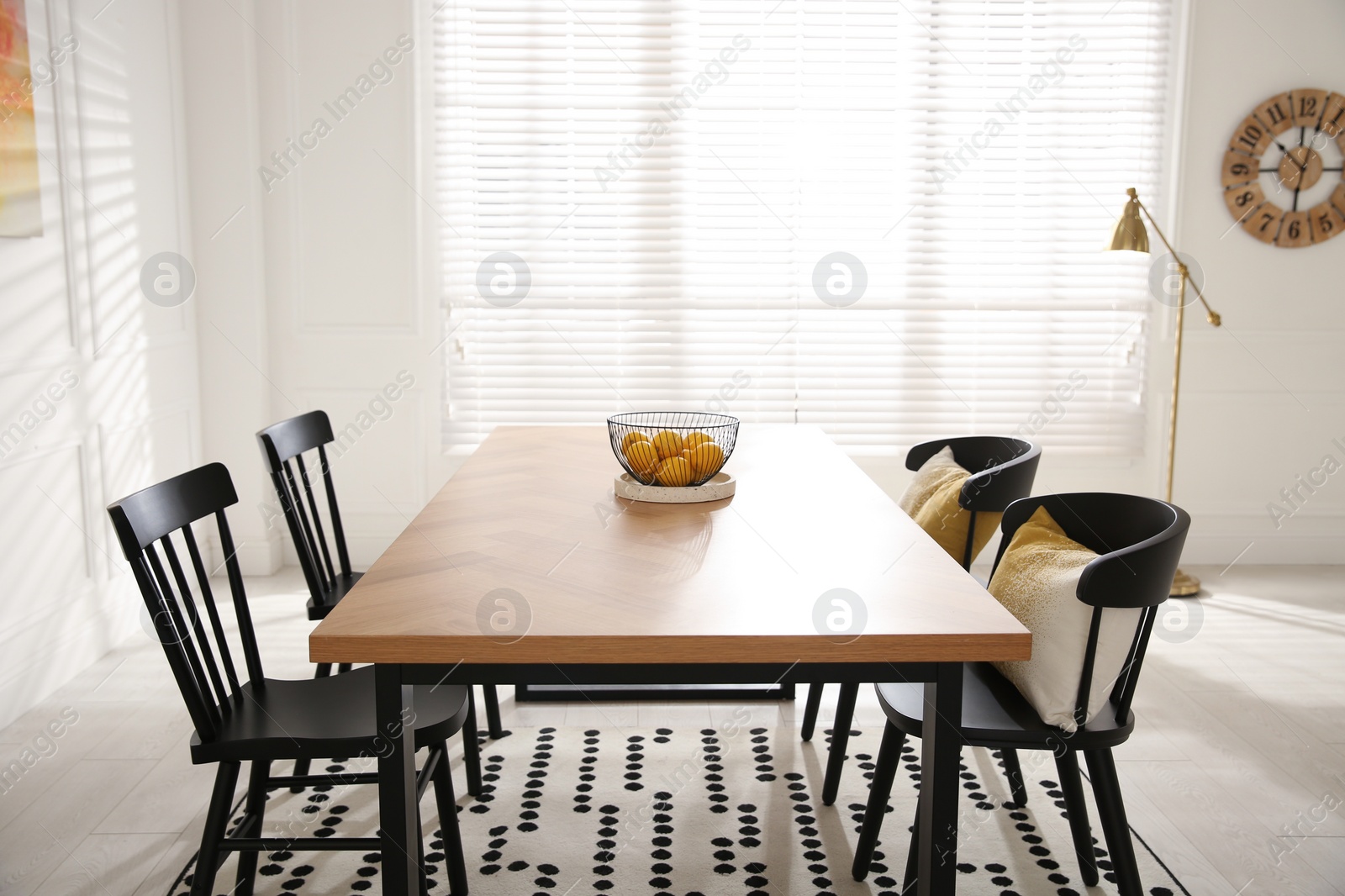 Photo of Stylish wooden dining table and chairs in room. Interior design