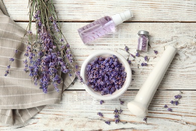 Flat lay composition with lavender flowers and natural cosmetic on wooden background