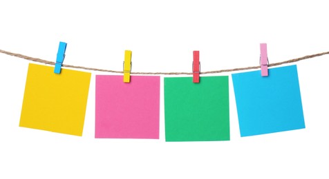 Photo of Clothespins with empty notepapers on string against white background. Space for text