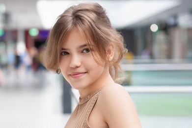 Portrait of beautiful teenage girl in shopping mall
