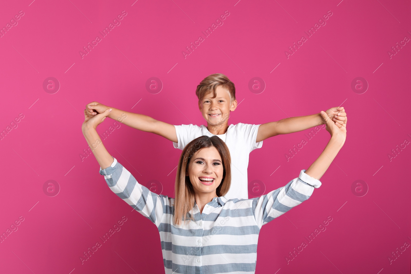 Photo of Portrait of mother and son on color background