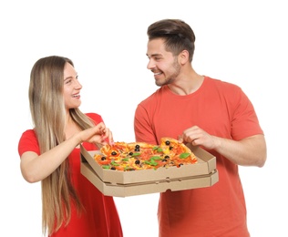 Photo of Attractive young couple with delicious pizza on white background