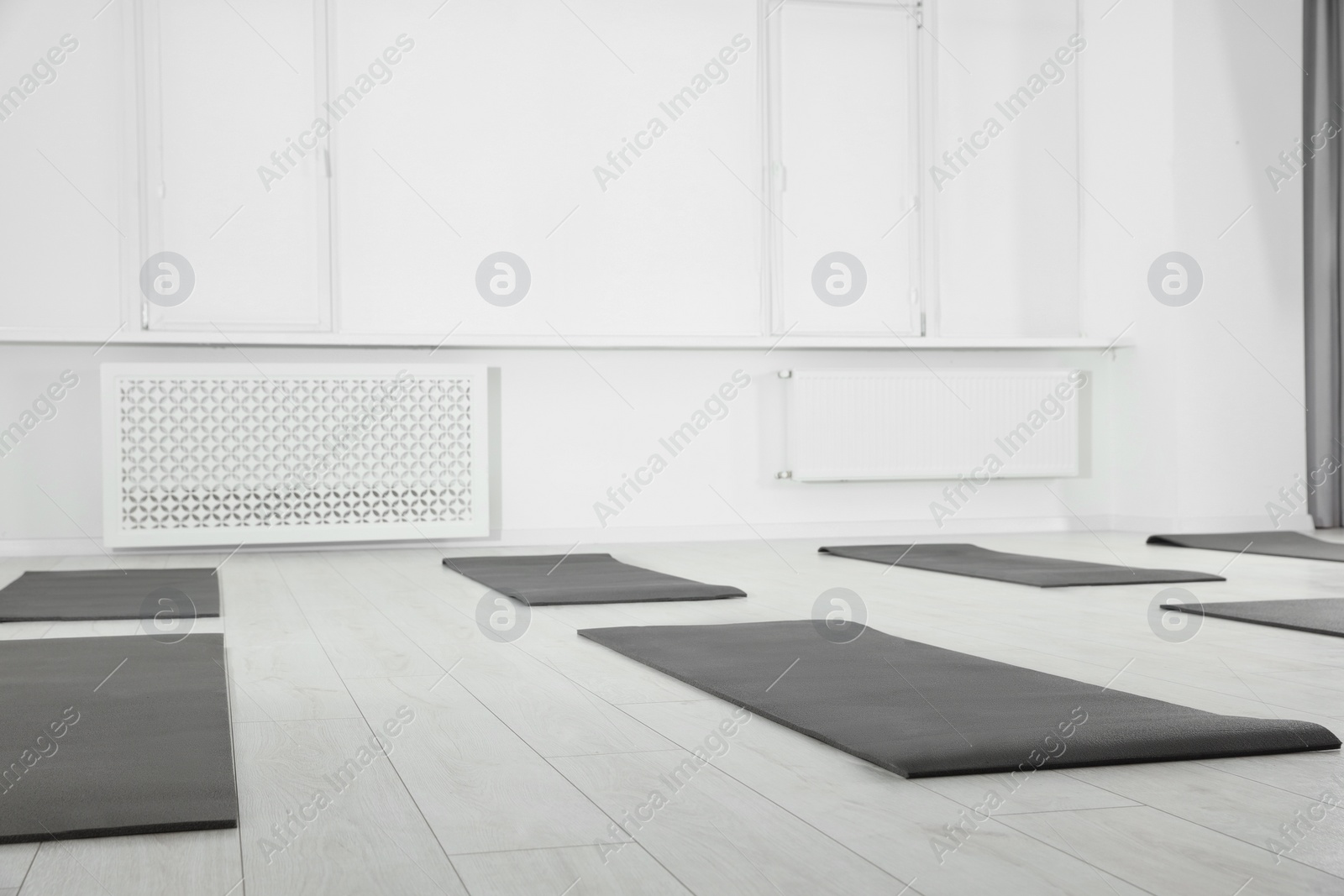 Photo of Spacious yoga studio with exercise mats on floor