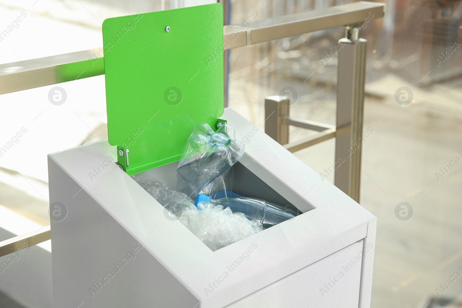 Photo of Metal bin with garbage indoors. Waste recycling