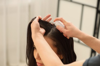 Photo of Hair styling. Professional hairdresser working with client indoors, closeup