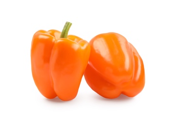 Photo of Ripe orange bell peppers isolated on white