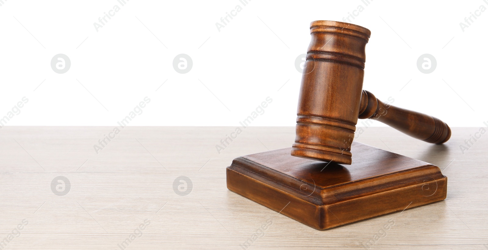 Photo of Wooden gavel on light table against white background. Space for text