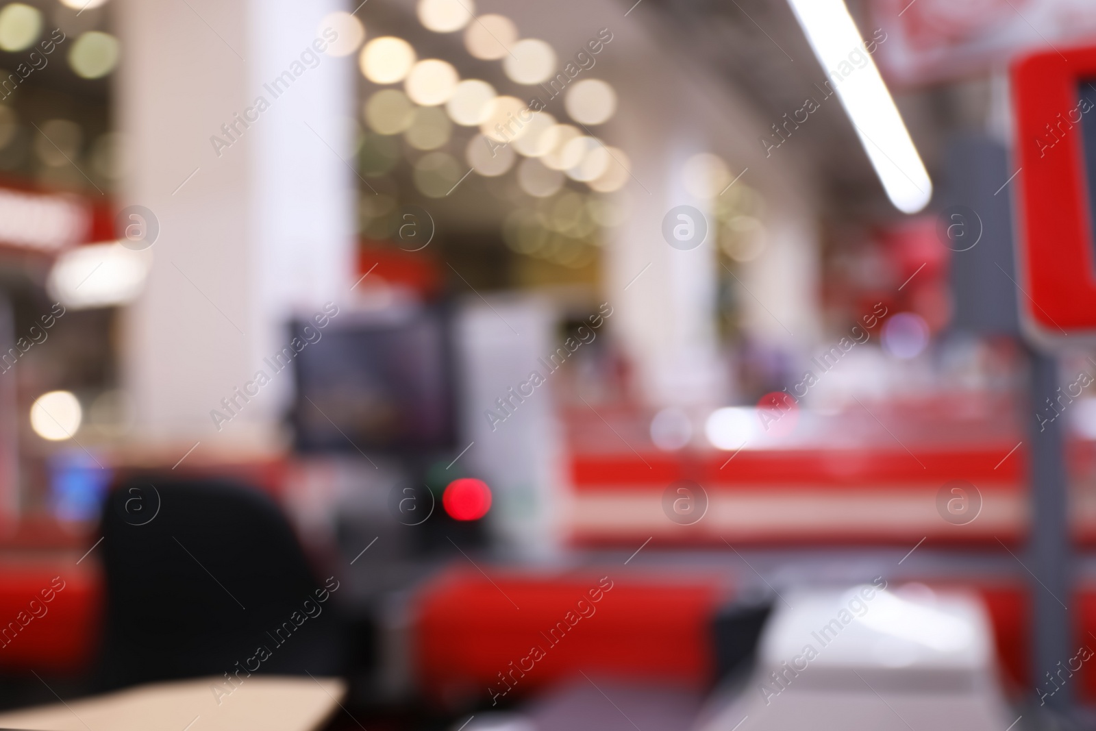 Photo of Blurred view of checkout lanes in supermarket with bokeh effect