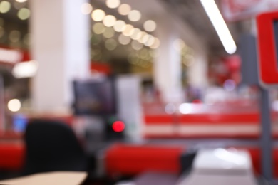 Photo of Blurred view of checkout lanes in supermarket with bokeh effect