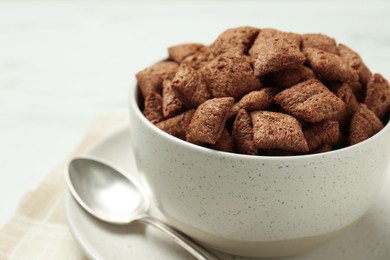 Photo of Bowl of sweet crispy chocolate corn pads on table, closeup