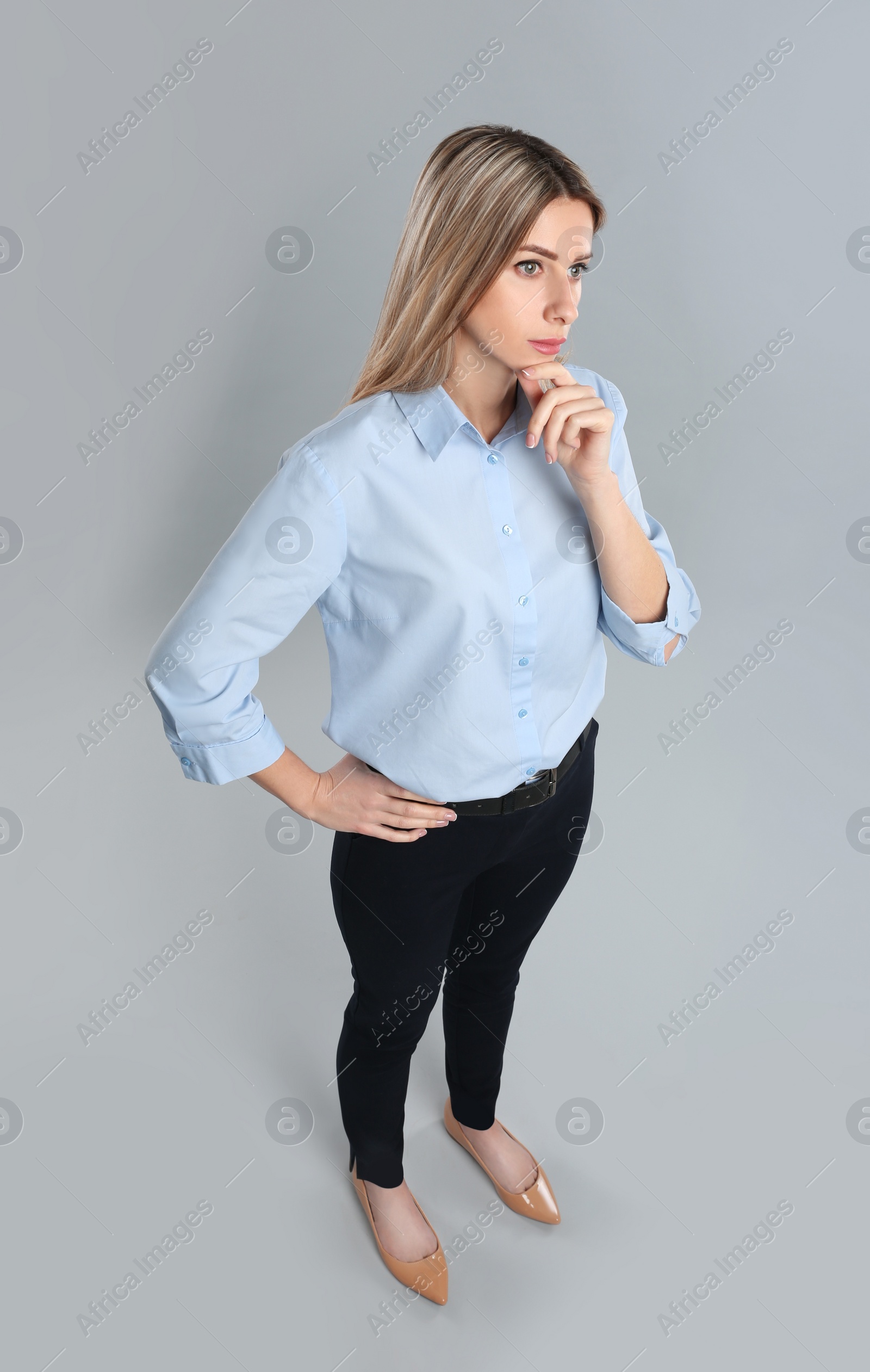 Photo of Young woman on grey background, above view