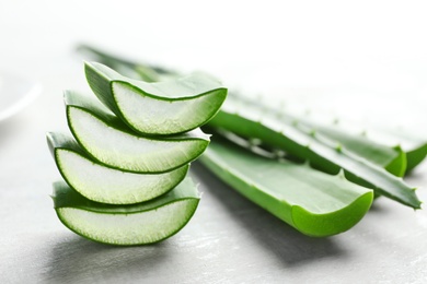 Photo of Fresh sliced aloe vera leaves on light background