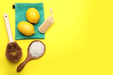 Flat lay composition with eco friendly products on yellow background, space for text