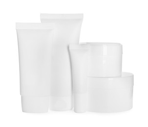 Photo of Blank tubes and jars of cosmetic products on white background