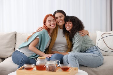 Happy young friends spending time together at home