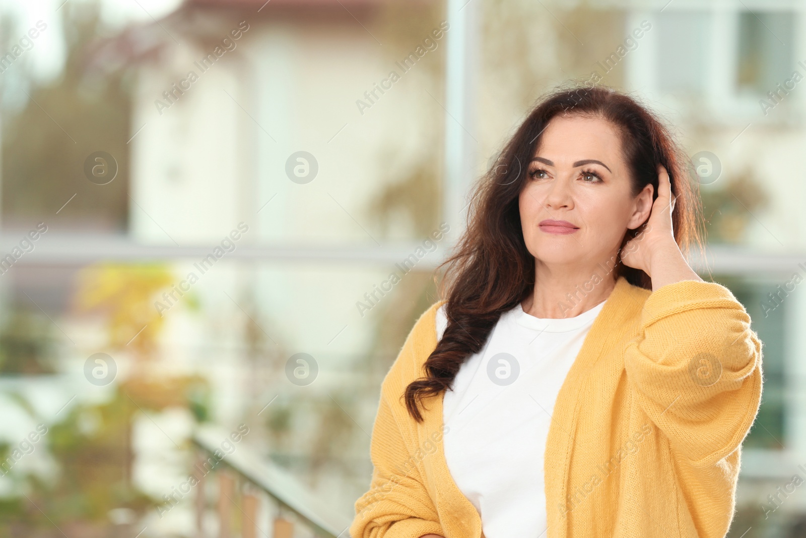 Photo of Portrait of beautiful older woman against blurred background with space for text