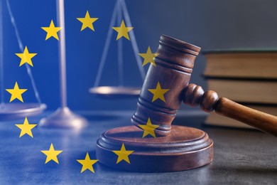 Image of Double exposure of European union flag and judge's gavel on grey table