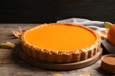 Fresh delicious homemade pumpkin pie served on wooden table