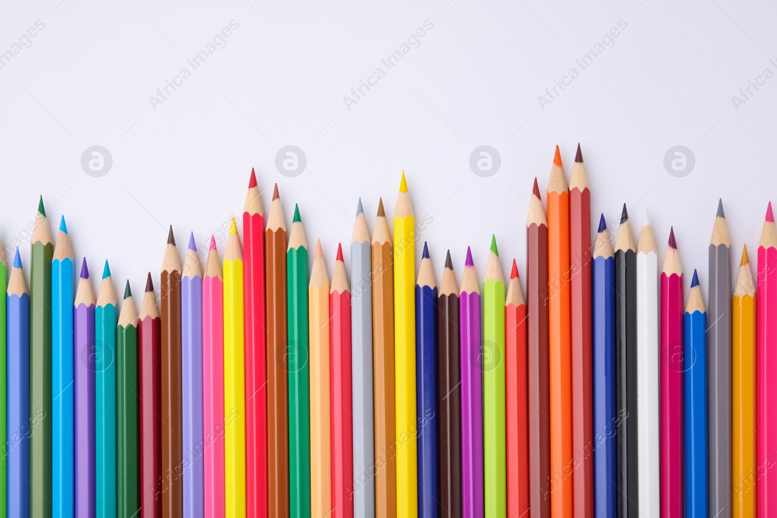 Photo of Colorful wooden pencils on white background, flat lay. Space for text