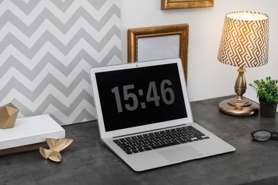 Photo of Stylish workplace with modern laptop on table indoors