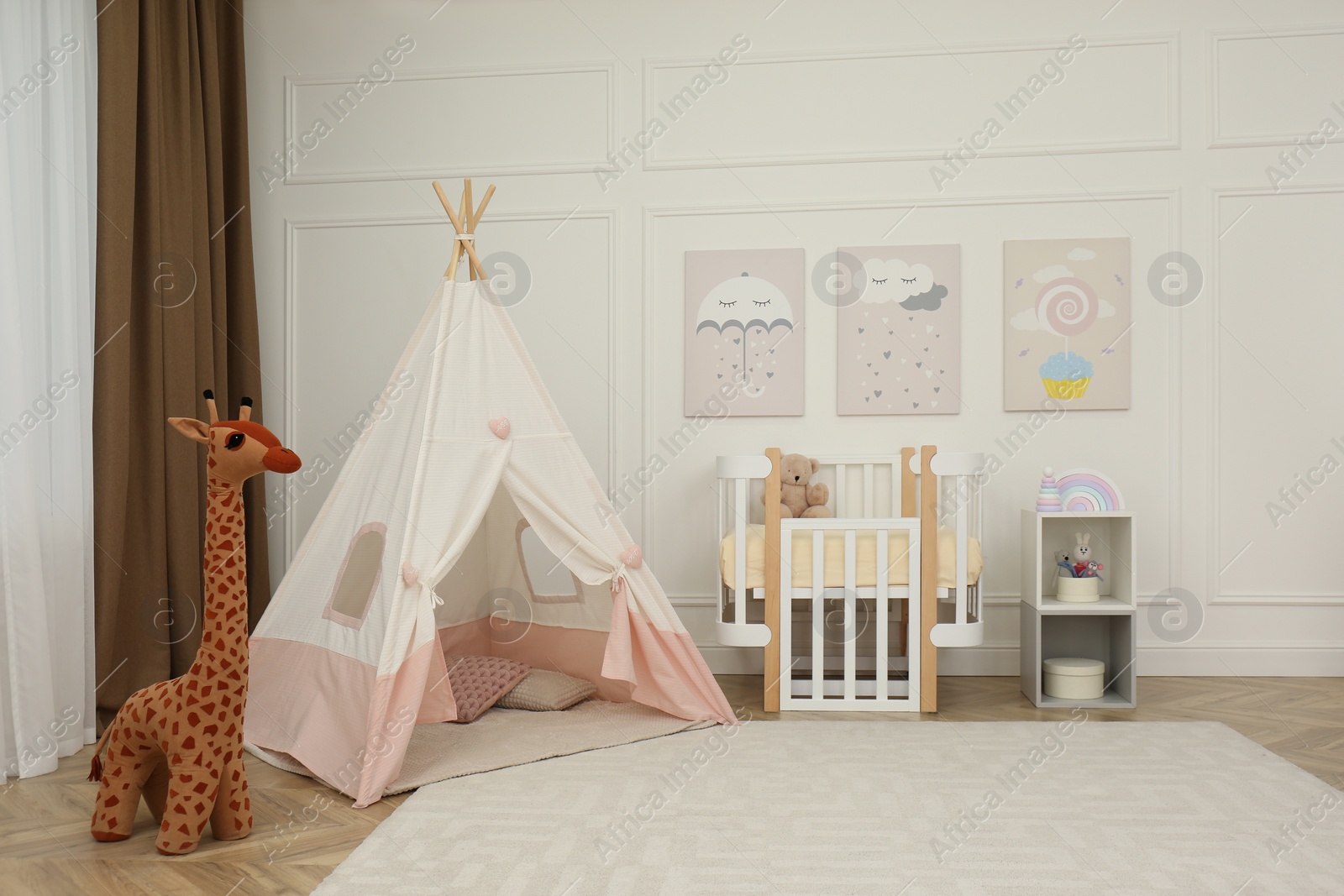 Photo of Cute baby room interior with crib and play tent