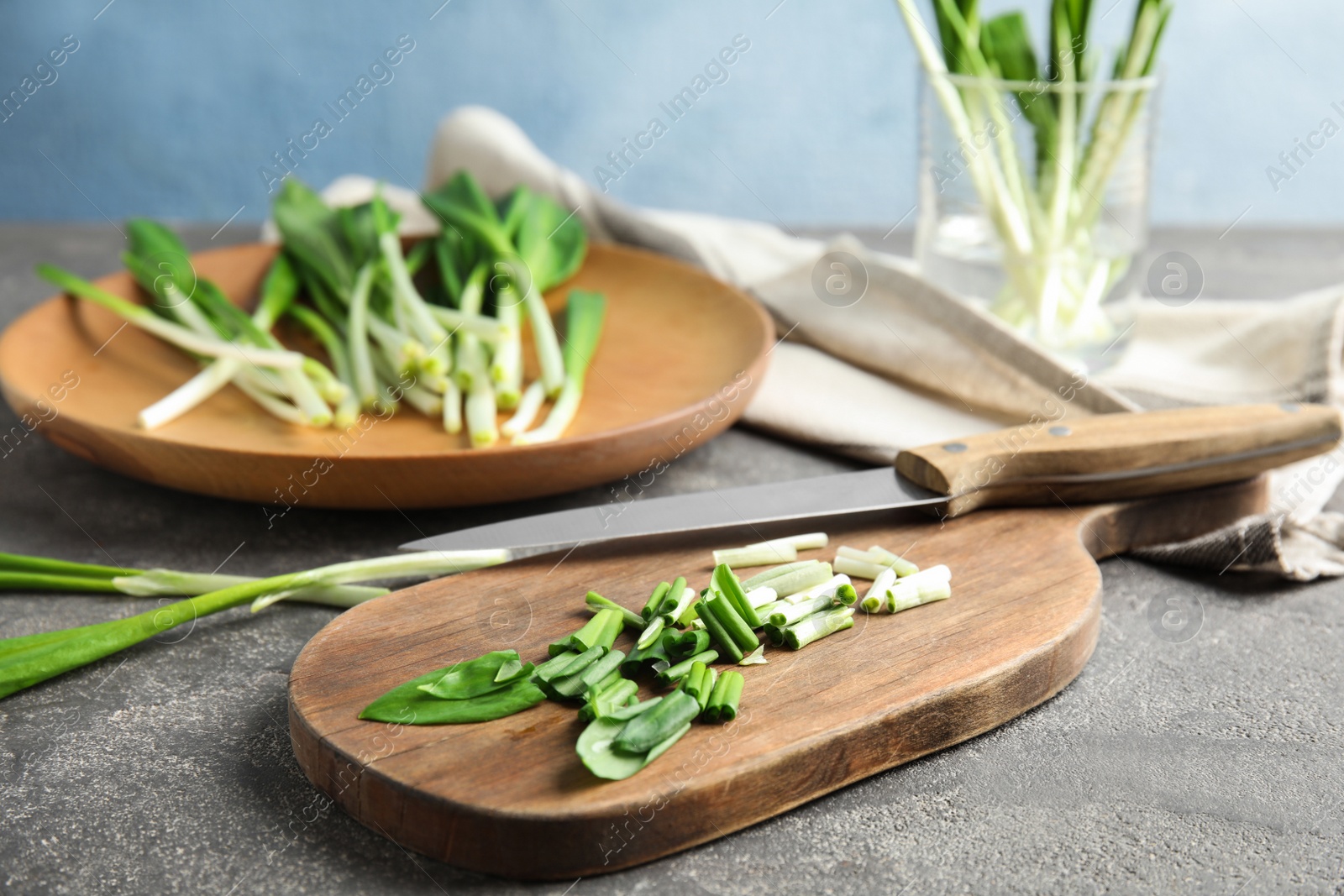 Photo of Composition with wild garlic or ramson on grey table